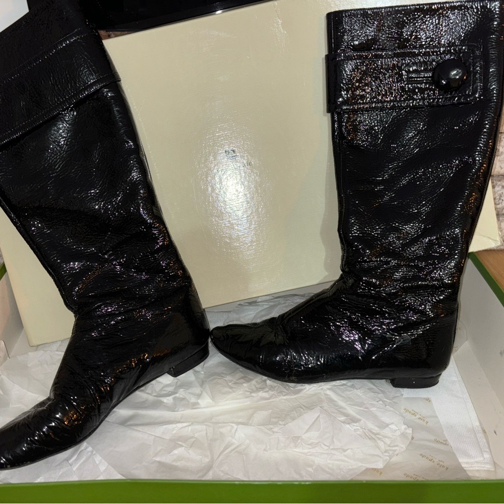 Black glossy boots. Size 7 with button on the side. They zip up in the back.